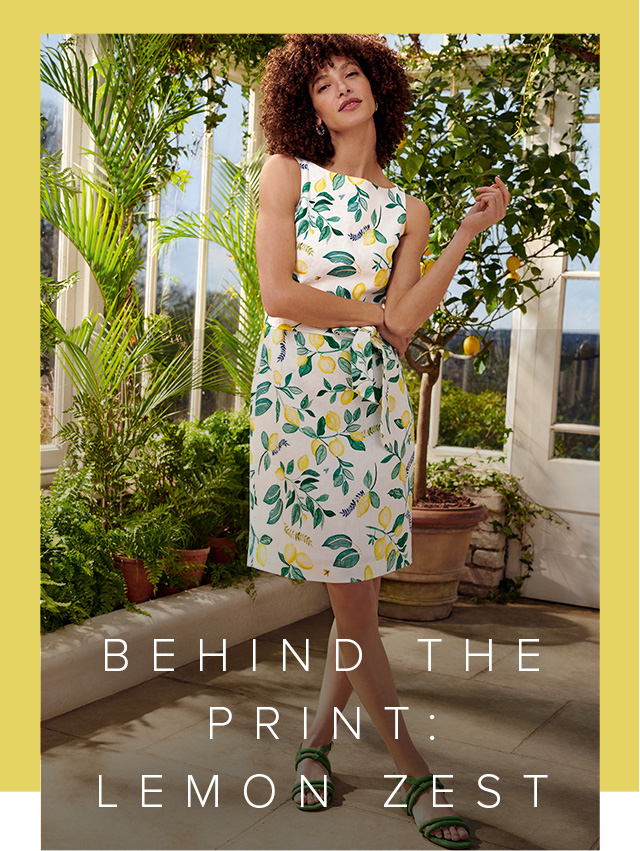 Model photographed in a conservatory wearing Hobbs lemon print summer dress.