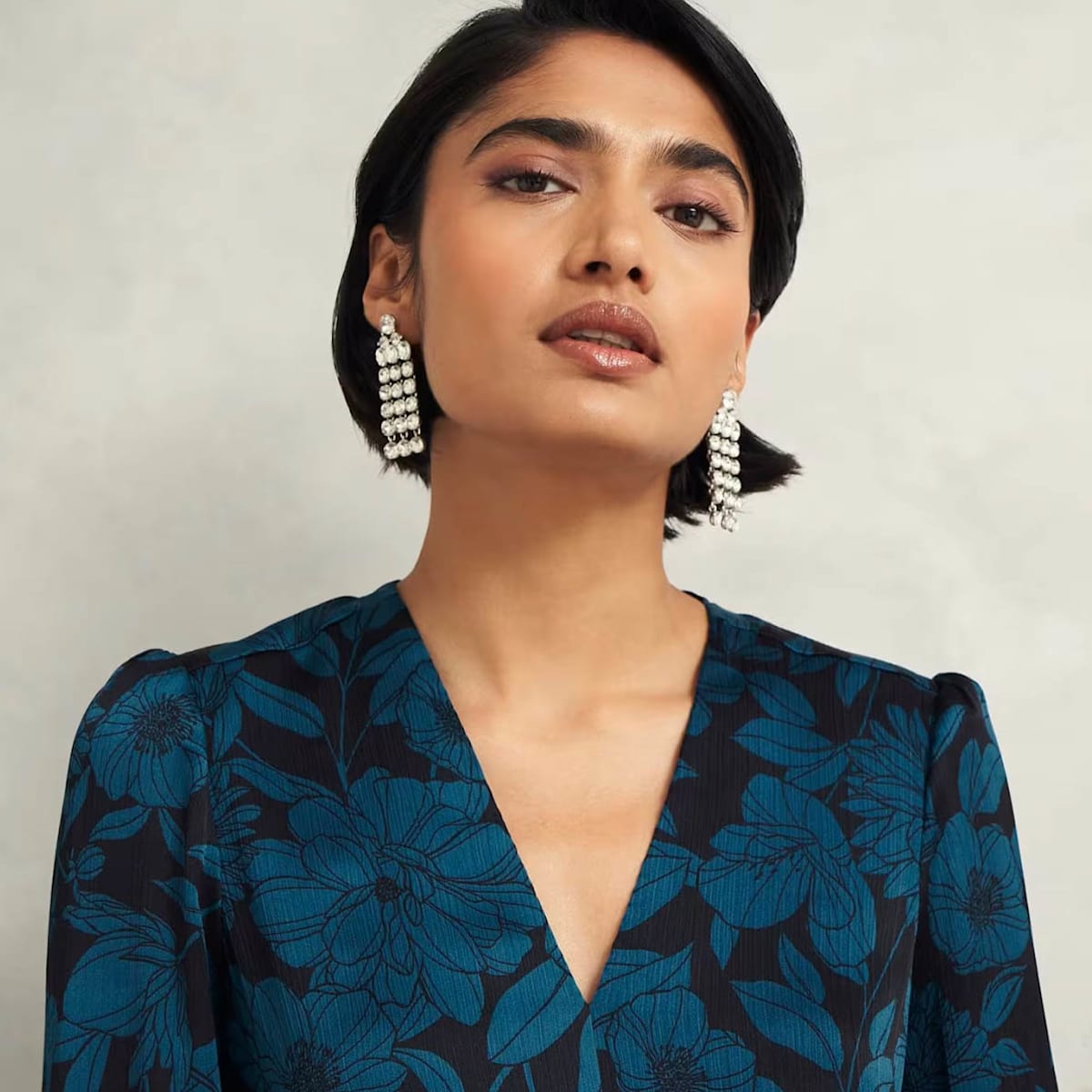 An image of a model wearing a floral print occasion dress.