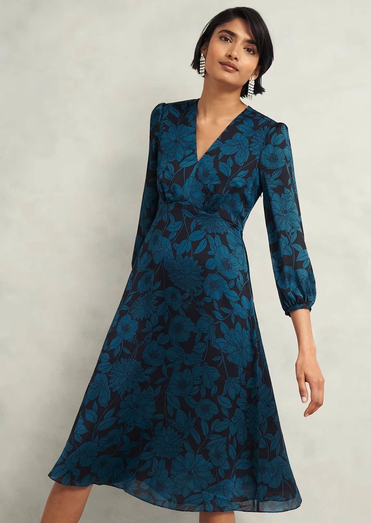 An image of a model wearing a floral print occasion dress.