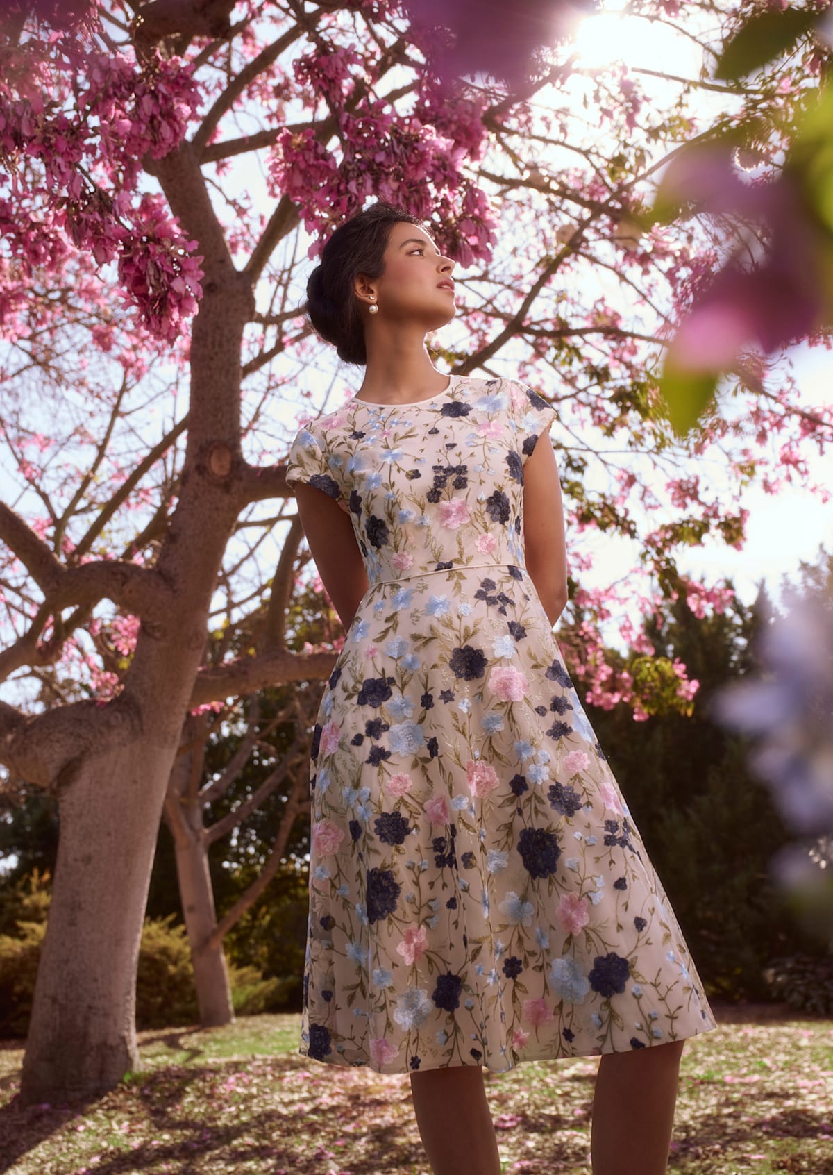 An image of a model wearing a floral-embroidered midi dress from Hobbs.