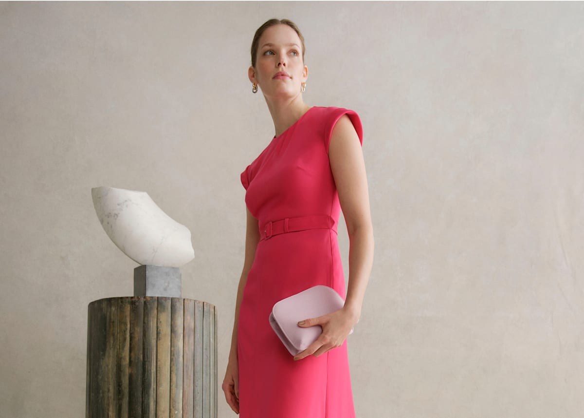 An image of a model wearing a Hobbs pink occasion dress.