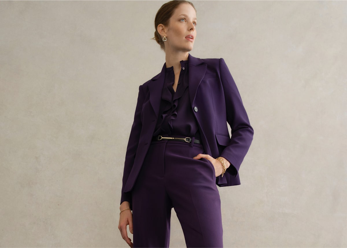 An image of a model wearing a women’s purple suit.
