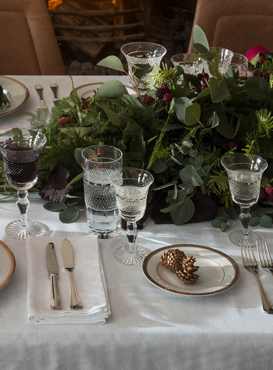 Birds eye view of a dining table set for a Christmas dinner.
