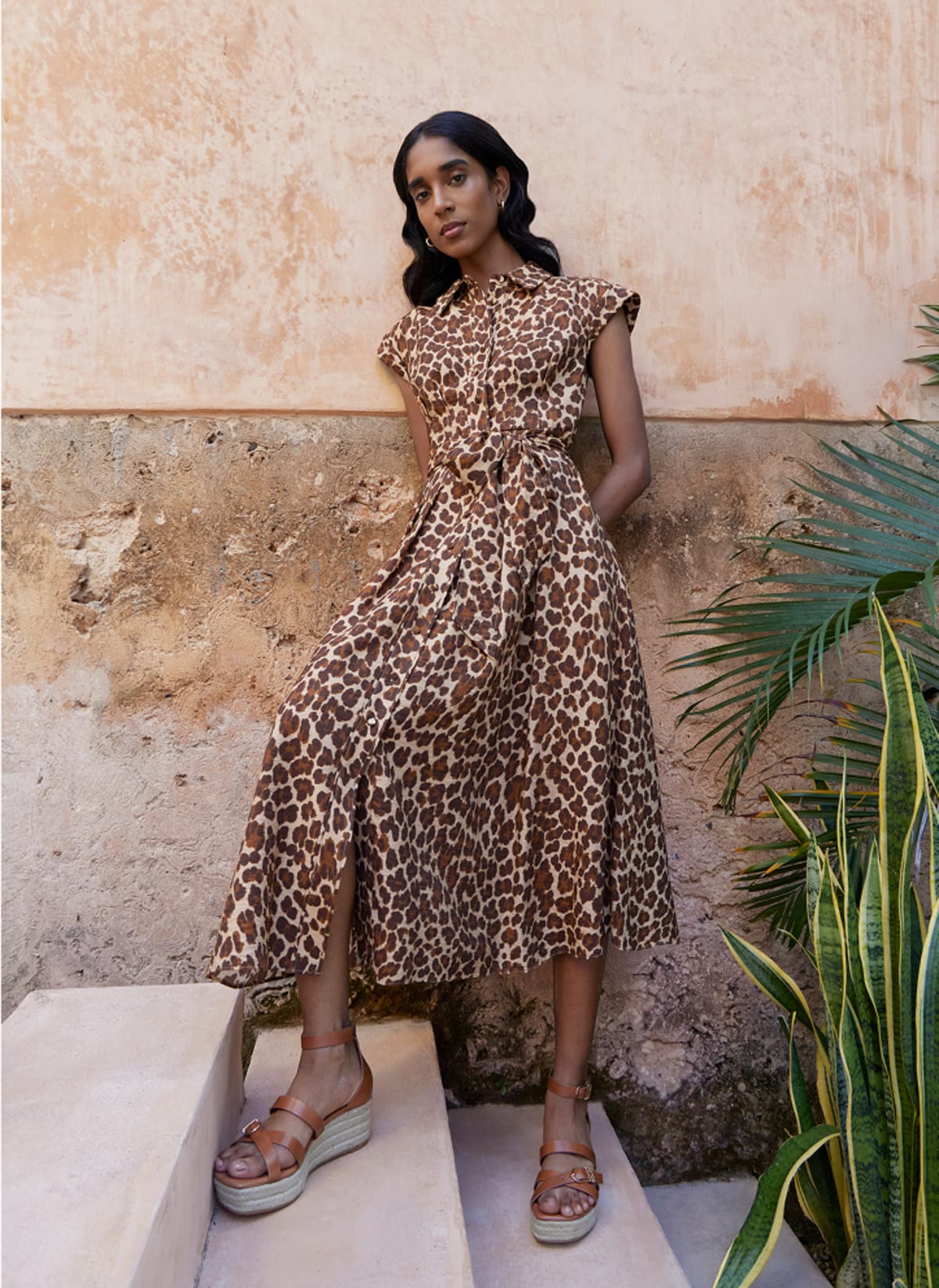 Model photographed in brown dress.
