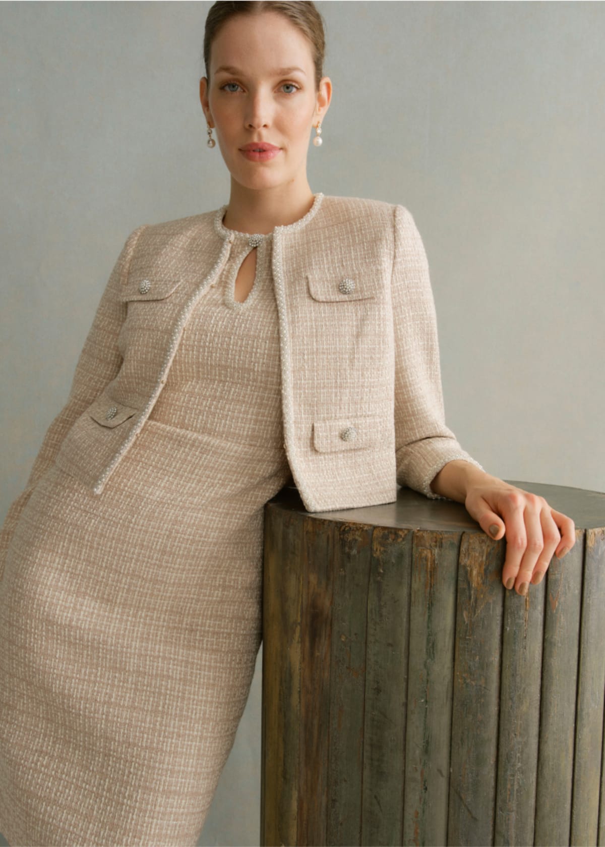 A gallery of two images of models wearing occasion coords in neutral colors.