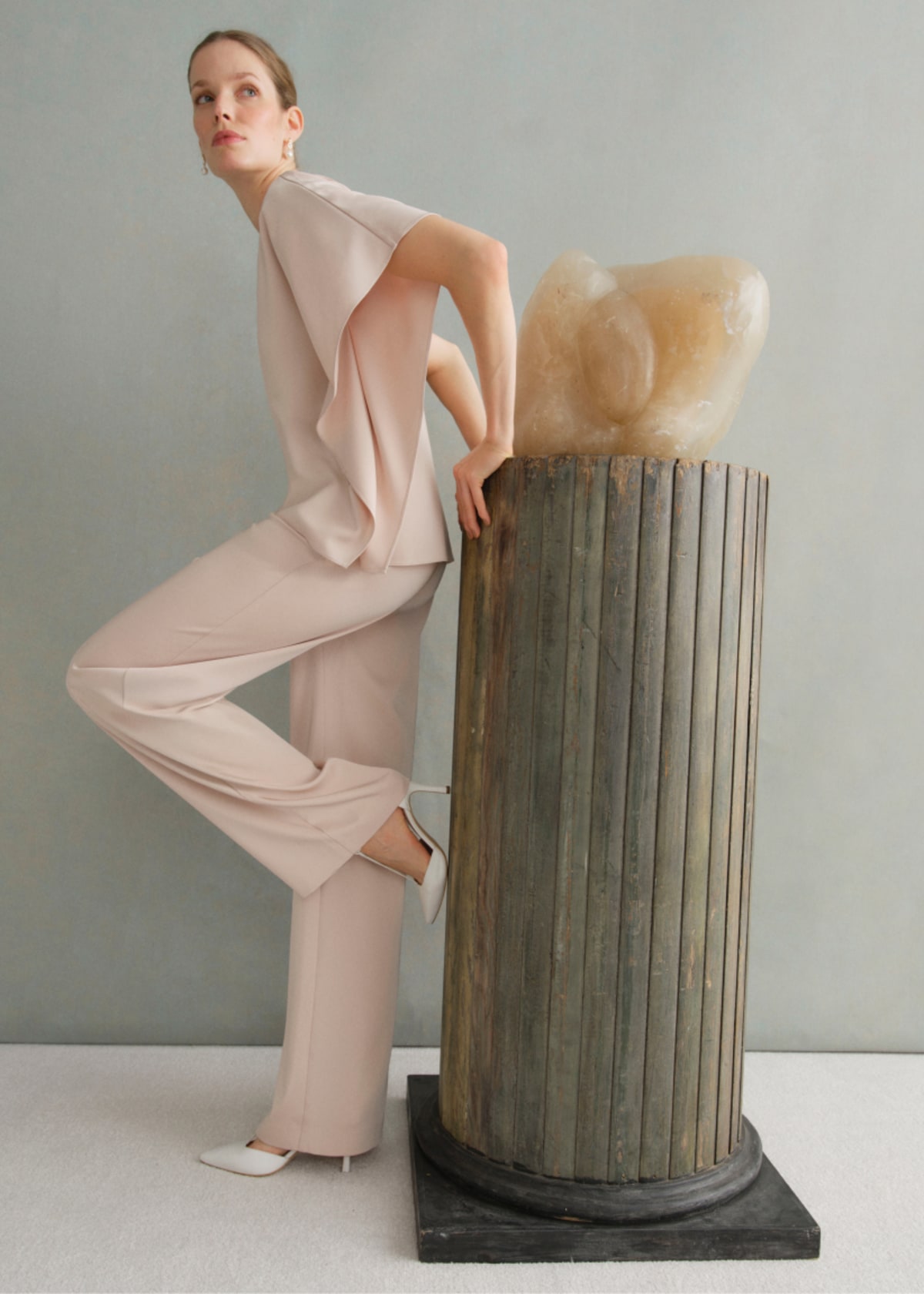 A gallery of two images of models wearing occasion coords in neutral colors.