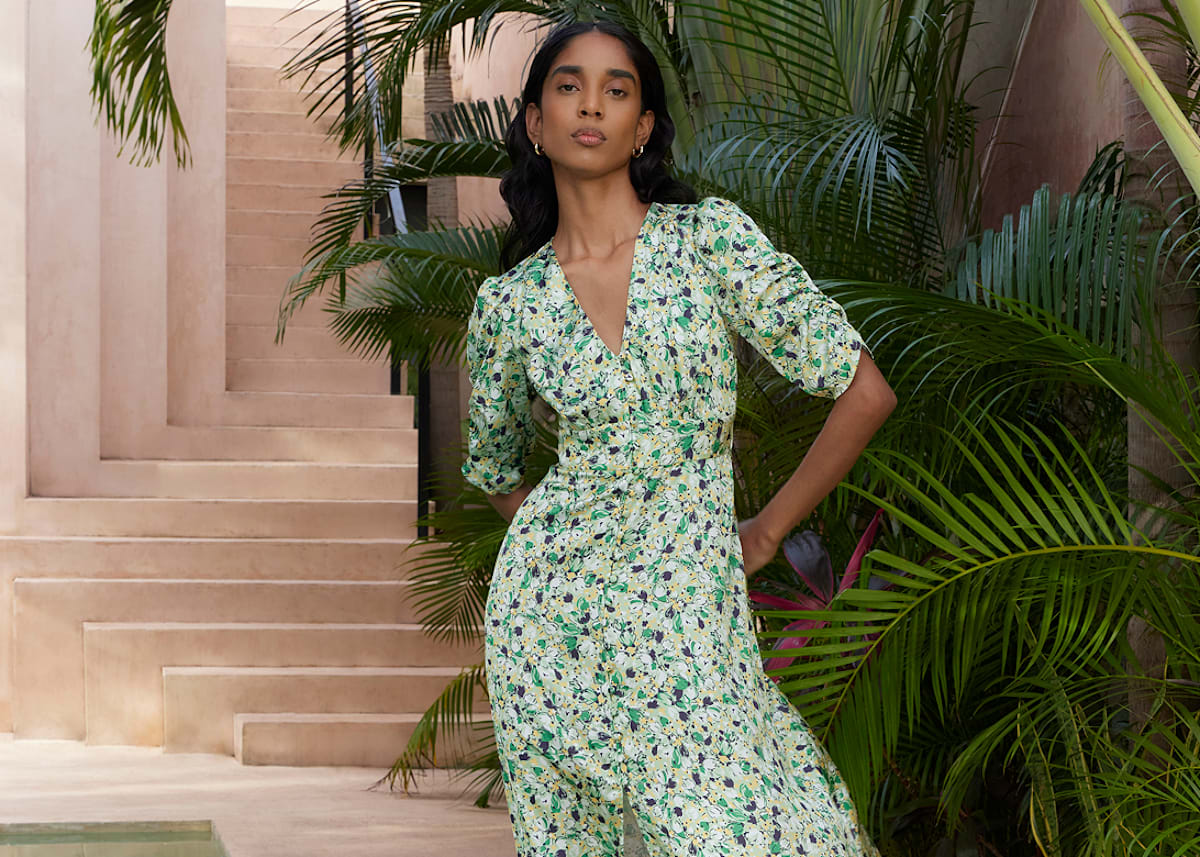 Model photographed in a green dress.