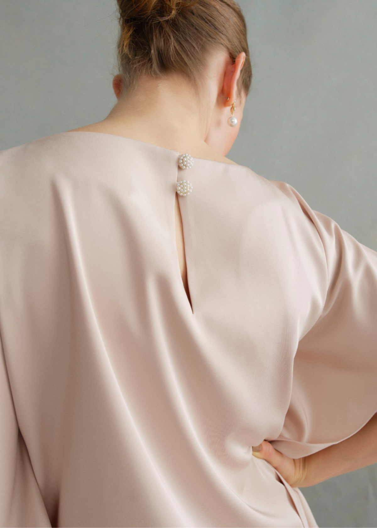 A gallery of two images of models wearing occasion coords in neutral colors.