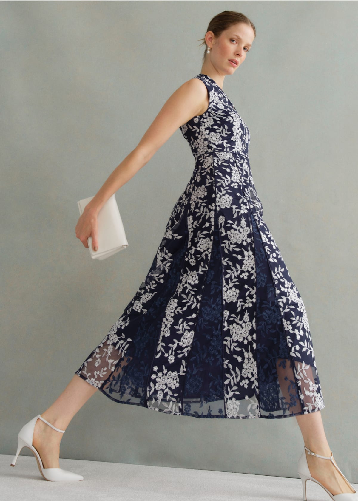 A gallery of two images of models wearing occasion floral midi dresses.