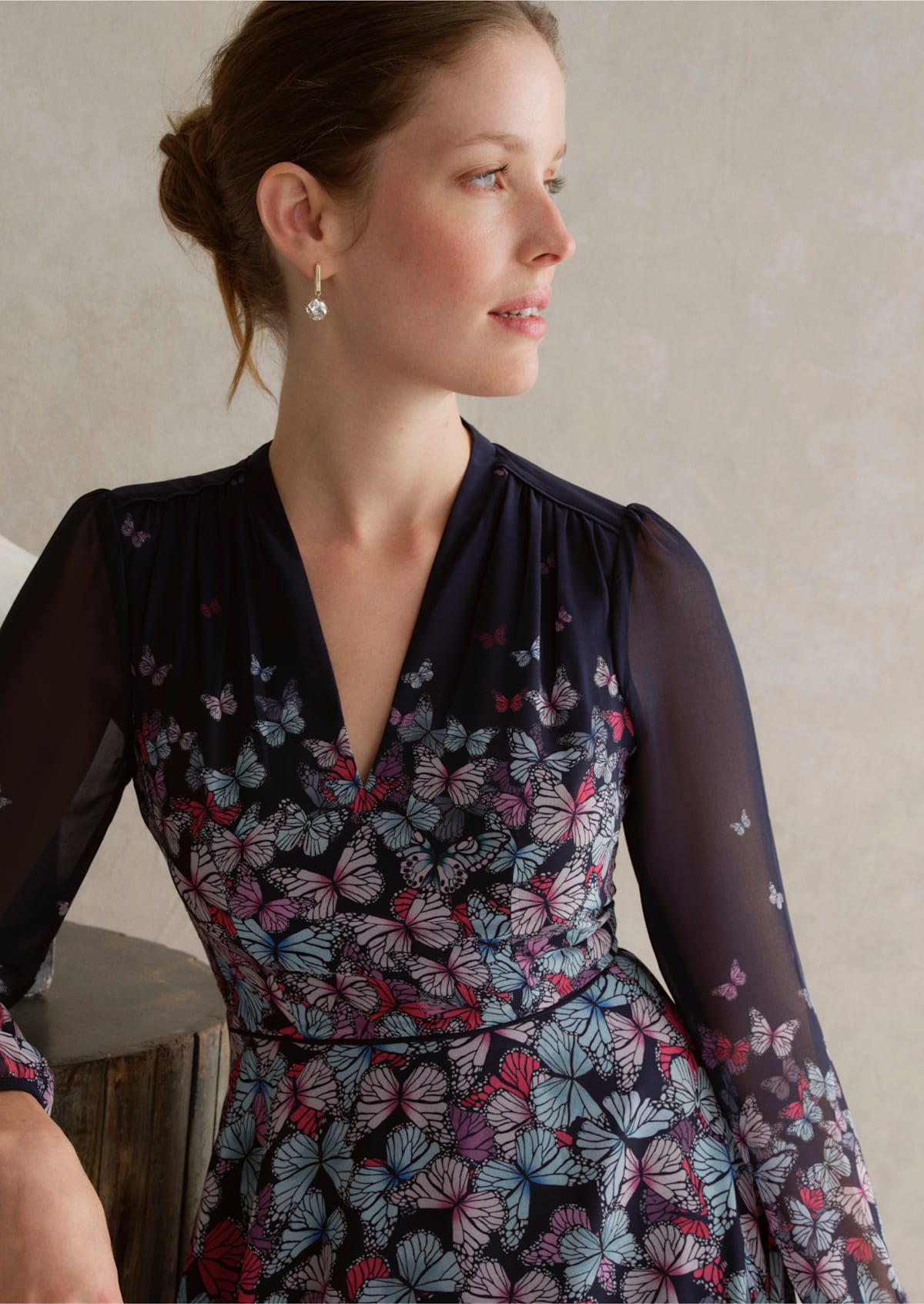 An image of a model wearing a navy occasion floral dress.