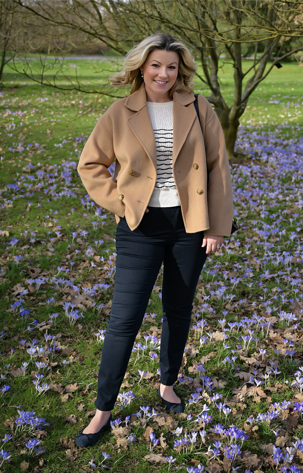 Singer Natalie Rushdie photographed on a walk wearing Hobbs Rosanna camel jacket, Daniella jumper and Gia black jeans.