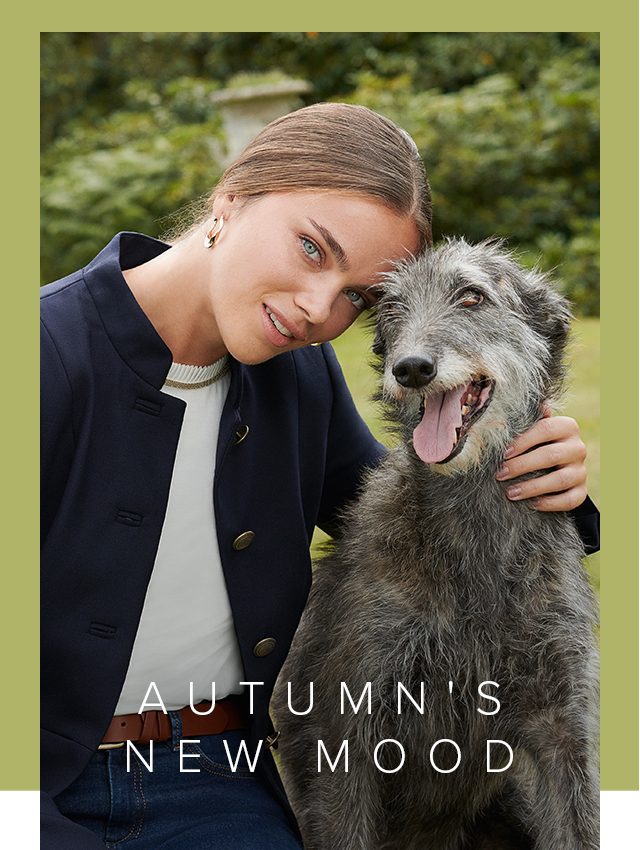 Model poses in a blue blazer next to a dog